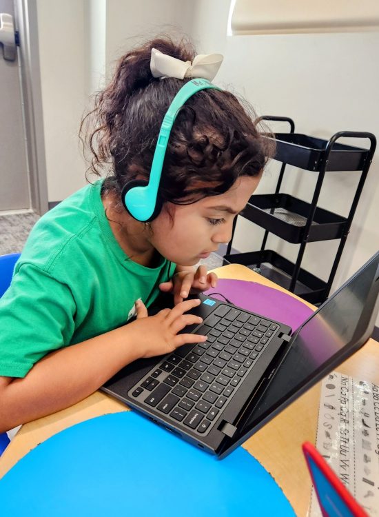 elementary student working on a laptop
